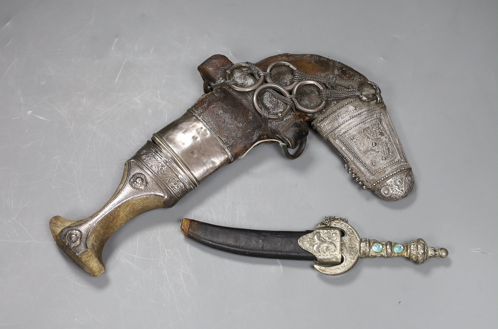 An Arab jambiya white metal dagger and one other ceremonial dagger